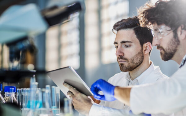 two scientist using digital tablet in laboratory