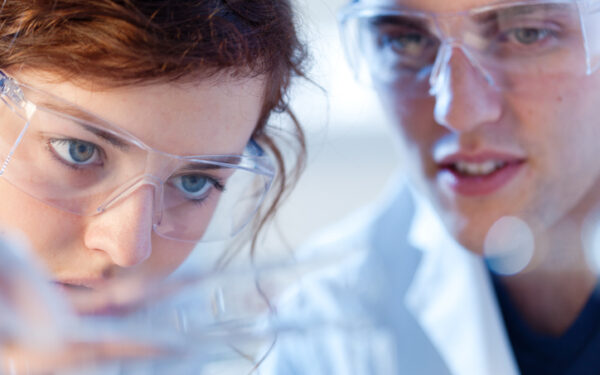 close up of research scienctists chemists working in laboratory horizontal