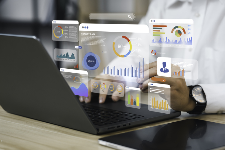an analyst uses a computer and dashboard for data business analysis and data management system with kpi and metrics connected to the database for technology finance, operations, sales, marketing