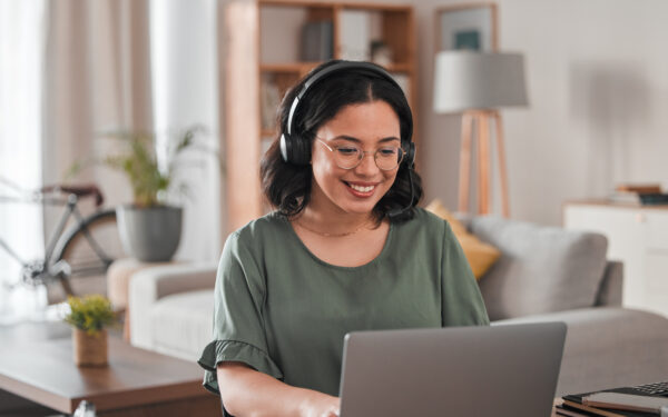 happy, remote work and woman with a laptop for call center communication and consultation. smile, virtual assistant and a customer service agent typing on a computer from a house for telemarketing